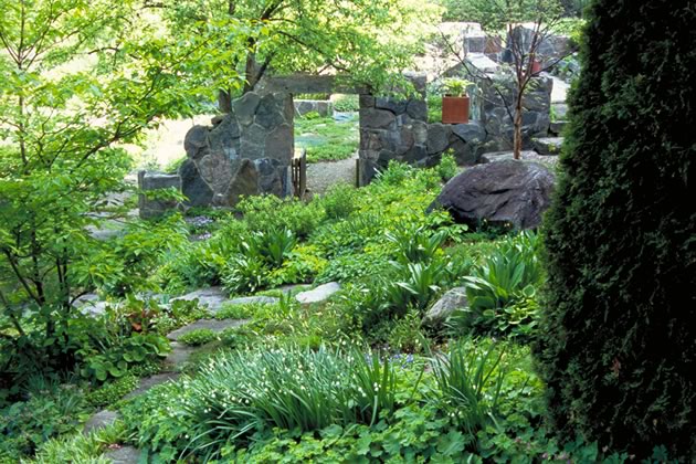 The charming garden ruin was con­structed from materials moved from an ancient barn foundation elsewhere on the Stewart property. Photo by Rosemary Hasner / Black Dog Creative Arts.