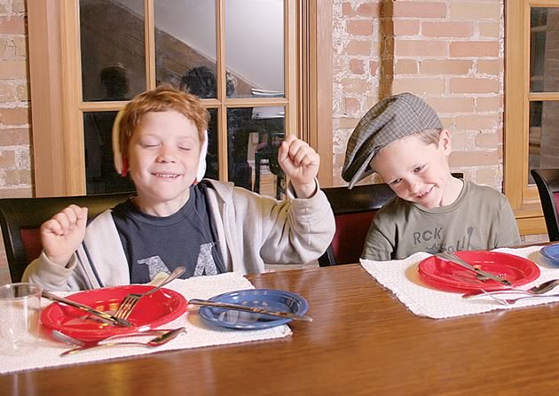 What not to do: Liam and Riley demonstrate some dinner table “don’ts” with gusto. Photo by Pauline Hayman.
