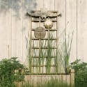 A trellis of reclaimed wood and a smattering of garden art lifts the eye upwards. Photo by Pete Paterson.
