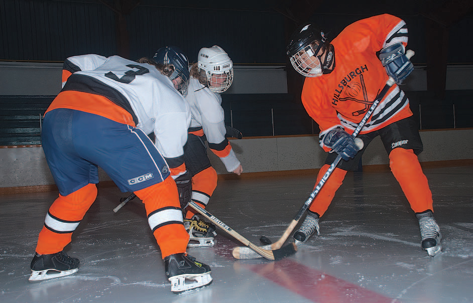 Vera Longstreet drops the puck as Siobhan Renouf and Sally Fitzpatrick square off. Photo by Rosemary Hasner