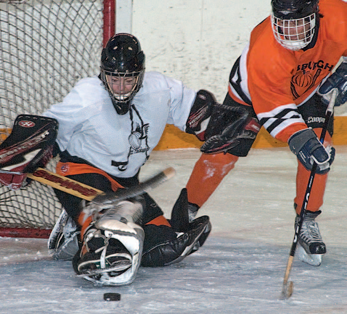 Goalie Mary Grace Blair fends off a deke by Sally Fitzpatrick, Photo by Rosemary Hasner