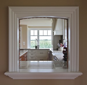 A window-like pass-through connects the cook to the dining room and provides an uninterrupted view from the front to the rear of the house.
