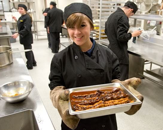 Alysha Muir and platter of succulent roasted ribs. Photo by Pete Paterson.