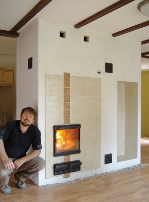 Alex Chernov with one of his masonry heater installations – each is custom designed. An average home can be heated with two high-efficiency firings a day. Photos Courtesy Alex Chernov / Stovemaster.