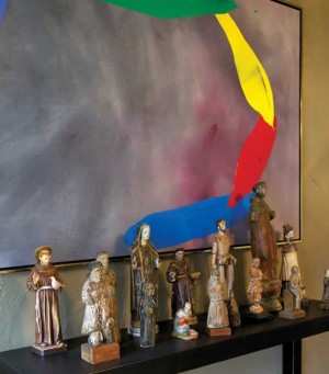 A group of santo figures contrasts strikingly with a bold abstract by Bill Perehudoff. Photo by Pam Purves.