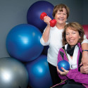 Nancy Frater (left) practises cardio and strength exercises with Terri Holden, whom she affectionately calls “the princess of pain.” Photo by Rosemary Hasner / Black Dog Creative Arts.