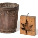Handmade and once painted a brilliant red, this sap bucket is a new donation to the museum. Like modern sap buckets, it hung beneath a spile, attached to a maple tree. Shaped maple sugar molds like this one were introduced to Quebec in the 1800s. Photo by Pete Paterson.
