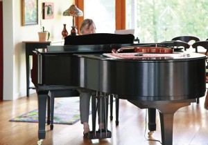 A grand piano is positioned between the living and dining areas, allowing Erica’s music to flow throughout the main level. Photo by Pam Purves.