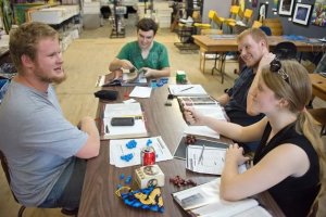 Unlike video games, the board games that attract the evening crowd at Koros Games require constant interaction among the player. Photo by Pete Paterson.