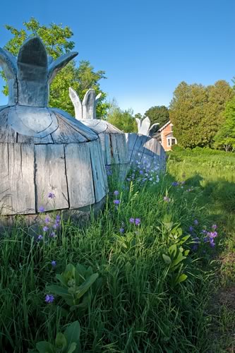 Art moves: Three massive pomegranate sculptures (facing page) made of iron, wood and lead, by New York artist Ilan Averbuch, punctuate a meadow of wild dame’s rocket to the west of the house. Photo by Rosemary Hasner / Black Dog Creative Arts.