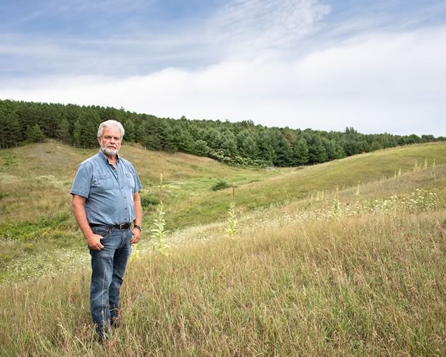 Sheep farmer Doug Cox says filling the gullies on his property to increase his herd and improve his profits is a normal farm practice. But in the absence of regulatory oversight, neighbours fear soil and water contamination. Photo by Pete Paterson.