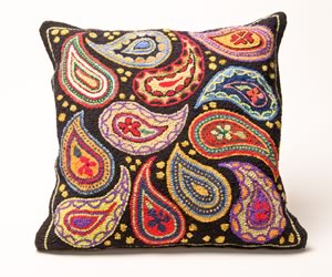 Warm up your chesterfield or reading nook with this paisley pillow made from a hand-hooked rug by fibre artist Martina Lesar in her log cabin studio in the Caledon hills.