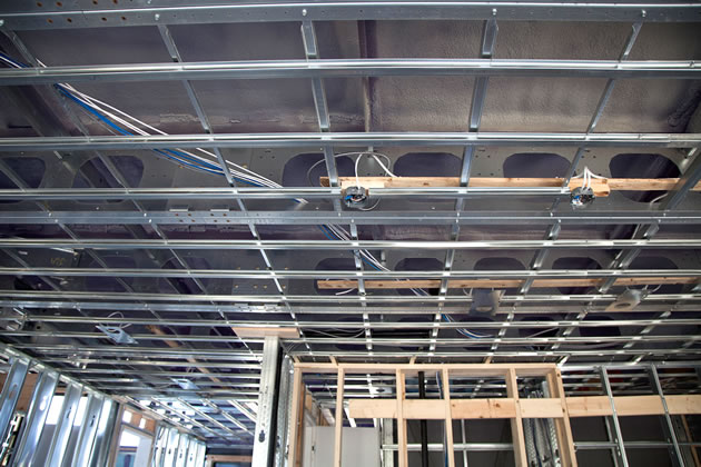 Lightweight steel frames the building and is precut for ducts and wiring. Photo by Pam Purves.