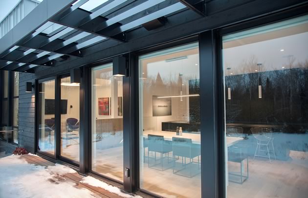 Metal, brick and wood cladding give the building profile colour and appeal. High efficiency windows keep out the cold and maximize the heat from sunlight. Photo by Pam Purves.
