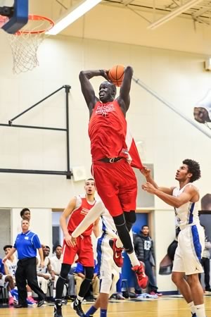 Thon Maker of Athlete Institute Prep is fouled while going up for a dunk against the Father Henry Carr basketball team in Etobicoke last fall. Photo by James MacDonald.