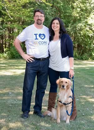 Volunteer puppy raisers Doug Maskell and Lynn Acri know service dog Joy won’t be with them forever, but they take comfort in knowing she will help improve someone’s life. Photo by Pete Paterson.