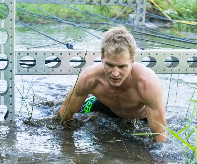 Ryan Atkins plows through a water obstacle. Photos by Fred Webster.