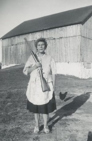 The fox as “enemy of the chicken coop” is firmly rooted in both mythology and reality. Competing with this clever animal was (and still is) a constant for rural people. Mary (Rolstin) Clarke (1897–1957), shown here c. 1945, was determined to keep her chickens safe at her farm on the 4th Line of Melancthon Township. Photo Courtesy Dufferin County Museum And Archives P-5374.