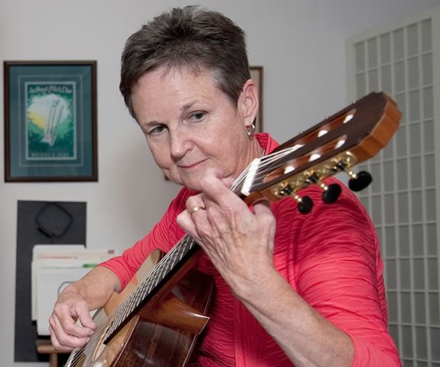 Lorraine McNally practises on the guitar made by her music teacher Daniel LaBrash. Photo by Rosemary Hasner / Black Dog Creative Arts.