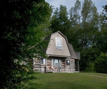 Steps from this quiet log cabin you’ll find waterfalls and hiking trails. Photo by Rosemary Hasner / Black Dog Creative Arts.