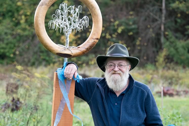 Jay Mowat with a sculpture by woodworker Jennifer McKinnon which his wife Clare gave him this year on his 65th birthday. Photo by Pete Paterson. 