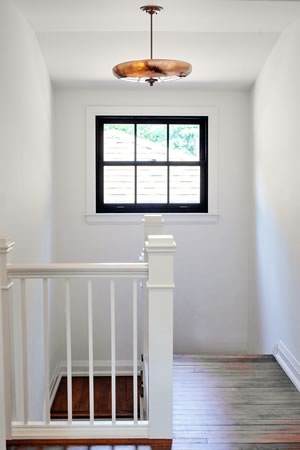 The second floor of the home is splendidly bright, thanks to its many unadorned windows. Photo by Nat Caron.