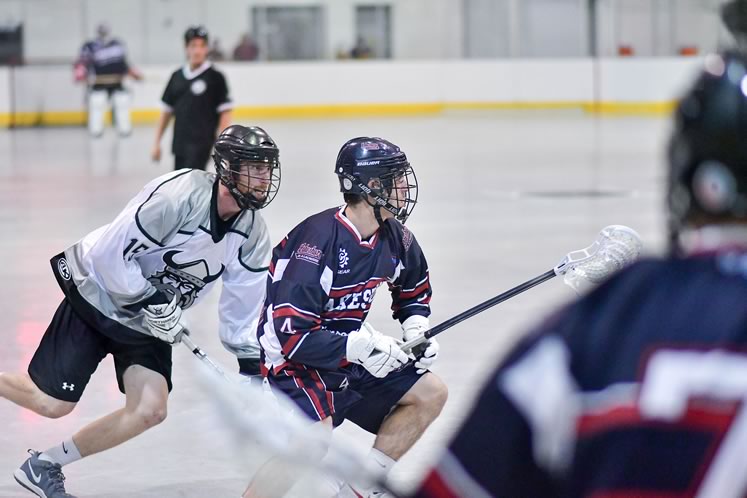 Jr. A Northmen box lacrosse player Kyle Staveley checking a Barrie opponent during a game in Orangeville last summer. The Northmen finished the season ranked in a threeway tie for fourth place. Photo by James MacDonald.