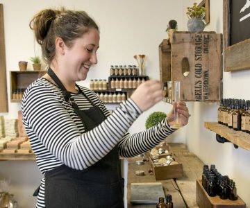 Jennifer Kleinpaste at her new store’s essential oil bar where she brainstorms scent blends for future products. Jennifer or staffer Jessica Marchildon also create signature blends for customers here. Photo by Pete Paterson.
