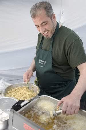 Rasmi AlHariri scoops raw falafel into the deep fryer at his family’s booth at Orangeville Farmers’ Market. Photo by Pete Paterson.