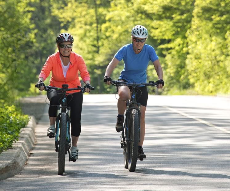 E-bike fan Liz Beatty and skeptic Nicola Ross recently took their motorized wheels for a ride on Forks of the Credit Road. Photo by Pete Paterson.