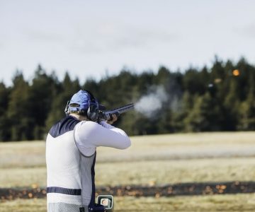 A trap shooter tests his skills with a 12-gauge pump-action shotgun. Photo by Visualspace | istockphoto.