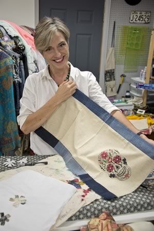 Textile artist Heather Chapplain shows off the fabrics she collects for the one-of-a-kind pieces she makes in her Alton studio. Photo by Rosemary Hasner / Black Dog Creative Arts.