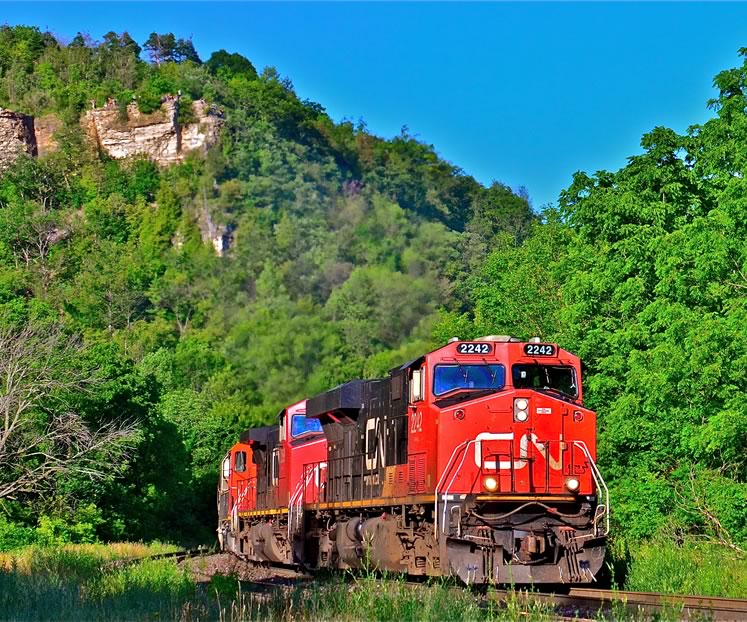 Dundas, ON – listening to the 12,000 combined horsepower of the locomotives being dragged down to 3 mph as they climb the Niagara Escarpment; the same scene repeated daily as the trains travel westbound through Campbellville. Photo by Brandon Muir.