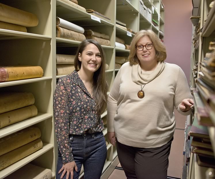 Curator Sarah Robinson (left) and archivist Laura Camilleri between the rolling shelves that house historic documents in the Museum of Dufferin. Laura and Sarah encourage people to talk to them about possible museum donations. “It’s the stories that help us decide what’s vital,” says Sarah. Photo by Pete Paterson.