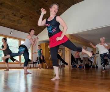 Mary Baxter (centre) and her co-instructor Sarah Butler (centre left) lead a Nia session at the Ecology Retreat Centre: “Fall in love with feeling good and the joy of movement.” Photo by Rosemary Hasner / Black Dog Creative Arts.