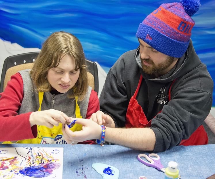 Sydney, who has been part of the program since its inception, gets a helping hand from staff member Colin Smits. Photo by Pete Paterson.