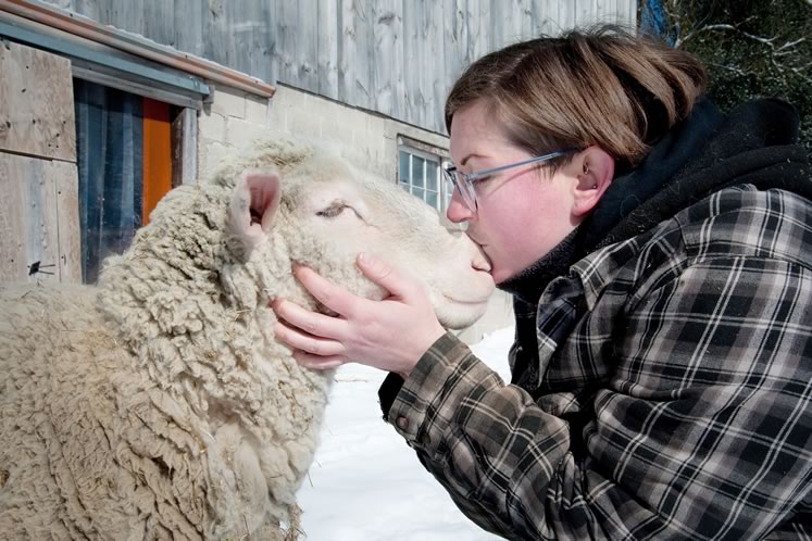 Ali Bisram nuzzles one of the rescued sheep she and her partner Faith care for at their Green Living Organic Farm Sanctuary. Photo by Rosemary Hasner / Black Dog Creative Arts.