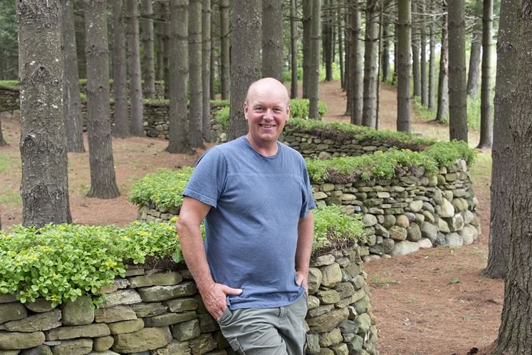 Dry stone waller Eric Landman stands on a private Caledon property where he has completed many walls and structures. Photo by Pete Paterson.