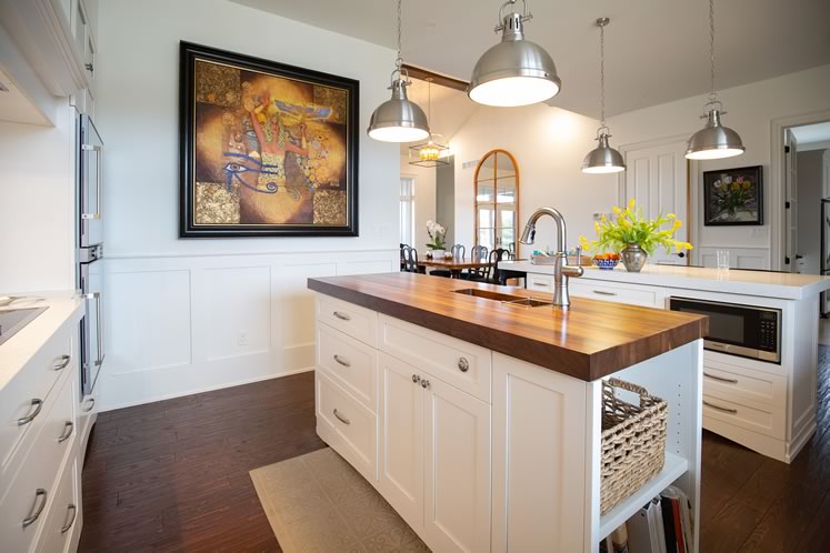 Local artist Paul Morin’s “Fountain of Innocence” overlooks the kitchen’s two islands – Deborah calls the wood-topped one her “private island.” Photo by Erin Fitzgibbon.