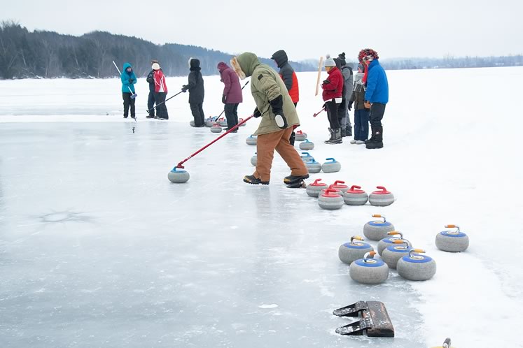 Curlers prepare to compete on a brisk February day at the pond spiel on Island Lake. Photo by Rosemary Hasner / Black Dog Creative Arts.