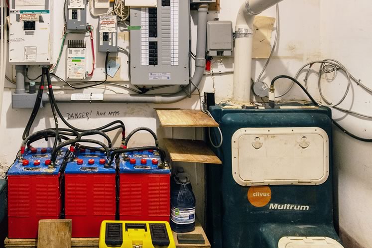 Batteries fed by solar and wind power are among the systems housed in Ketchum’s utility room. Photo by Erin Fitzgibbon.