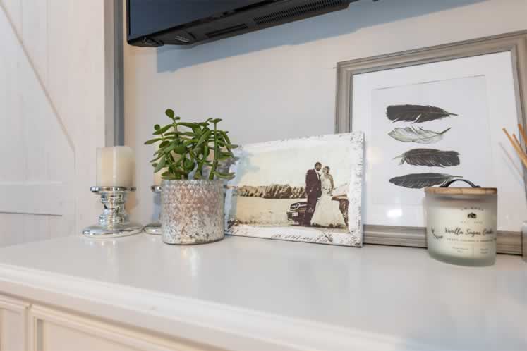 The calming principal bedroom features Shandor and Jacelyn’s wedding photo on a dresser. Photo by Erin Fitzgibbon. 