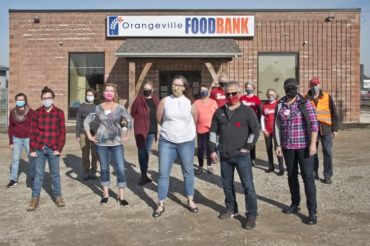 Some of the Orangeville Food Bank staff and volunteers, from left to right : Pam Vender, Laura Jotham, Claudette Riechart, Andrea Thomas, Heather Hayes, Jennifer Sinclair-Webb, Diana Engel, Gary Malone, Trevor Lewis, Vickie Lewis, Deanne Mount, Cathy Wilson and Steve White. Photo by Pete Paterson.