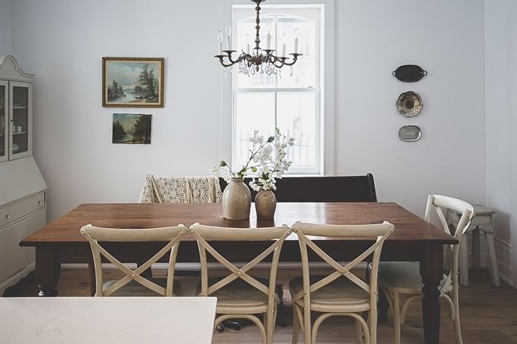 An antique harvest table dominates the dining area. Photo by Erin Fitzgibbon.