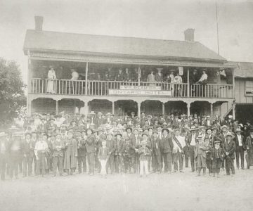 Huge crowds filled every community on Orangemen’s Day. In Caledon East, c.1900, the Ontario Hotel had to install extra balcony supports for this group photo. Photo courtesy Doris Porter.