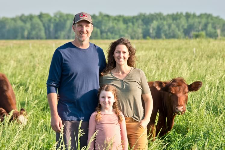 Jason Roney, Samantha Campbell and daughter, Amelia, 6, in lush pasture at Bennington Hills Farm. Photo by Pete Paterson.