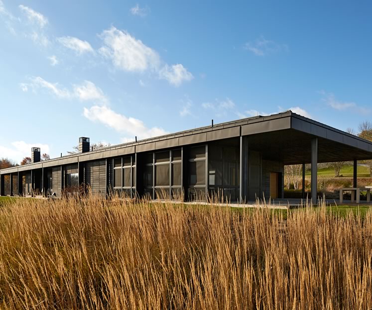 This all-black contemporary home is built into a hillside, affording the owners sweeping views eastward and protection from Mulmur’s famously harsh winter winds. Photo by Ben Rahn.