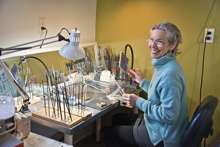 Artist Beth Grant creates lampwork beads at her worktable inside Orangeville’s Dragonfly Arts. Photo by Pete Paterson. 