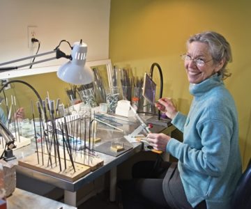 Artist Beth Grant creates lampwork beads at her worktable inside Orangeville’s Dragonfly Arts. Photo by Pete Paterson.