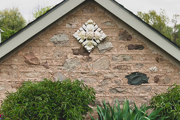 A dogwood blossom sculpture adorns the property’s original stone milk house. Photo by Erin Fitzgibbon.